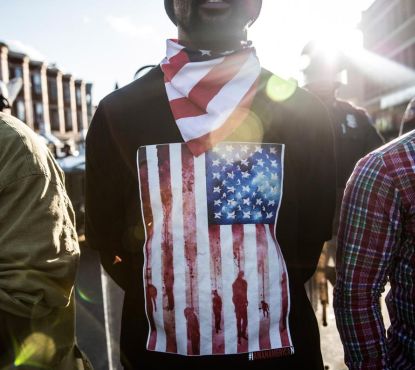 http://worldmeets.us/images/baltimore-unrest-man-flag_pic.jpg
